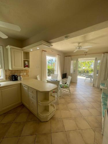 a kitchen with a table and a dining room at Kings Beach Village in Saint Peter