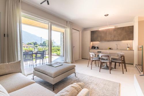 a living room with a couch and a table at Lago Dorato Luxury Apartments - Lake Como View in Colico