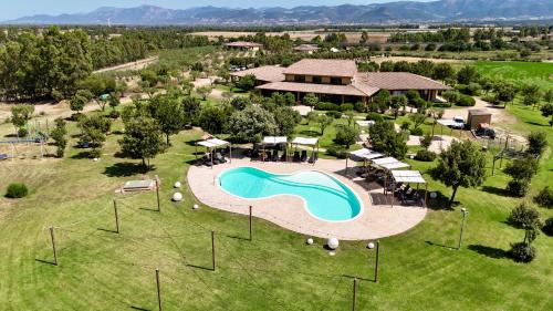 an aerial view of a resort with a swimming pool at Saludi&Trigu - Rural Apartments in Iglesias