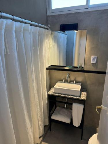 a bathroom with a sink and a mirror at Hotel America in San Juan