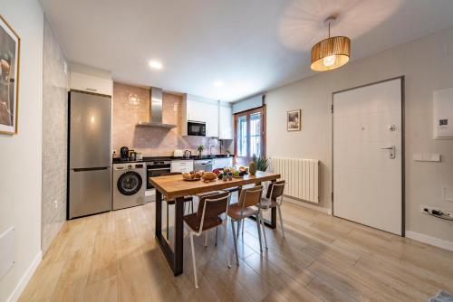 a kitchen with a table and chairs in a room at La Granja Villa in La Granja de San Ildefonso