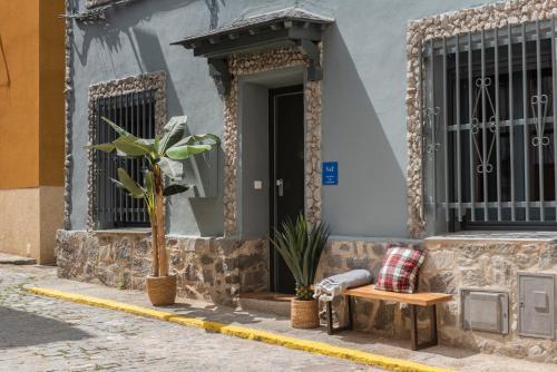 a house with a bench and a table and a door at La Granja Villa in La Granja de San Ildefonso