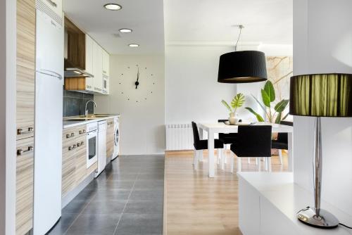 a kitchen with a table and a dining room at Casa LUNA la luna de CuentoGuía in Panticosa
