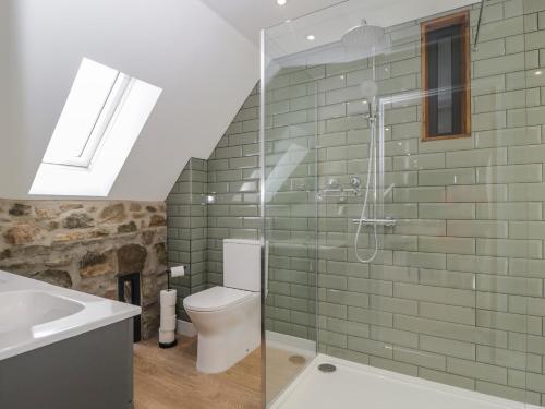 a bathroom with a shower and a toilet and a sink at The Hay Barn in Gloucester