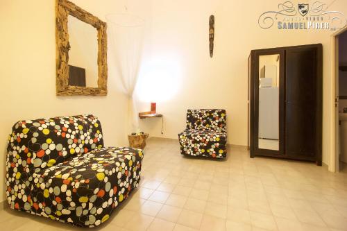 a living room with two chairs and a mirror at Orcéa & Spa Séjours Ecofriendly in Sainte-Anne