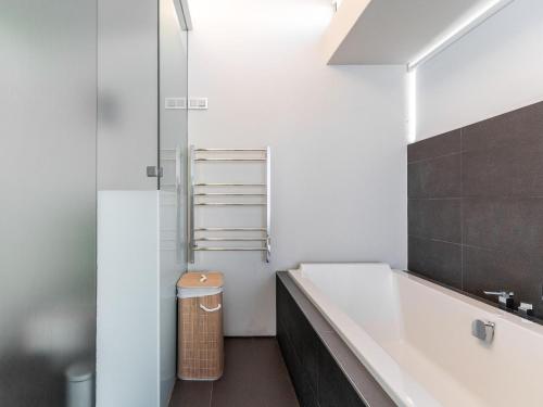a bathroom with a white tub and a shower at Beachfront Bliss in Cape Town