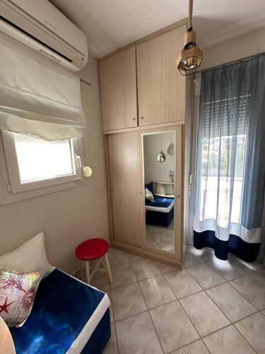 a bedroom with a bed and a window and a table at Cozy Blu in Nikiti