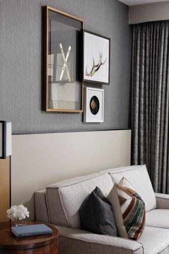 a living room with a couch and a clock on the wall at Four Seasons Resort Vail in Vail