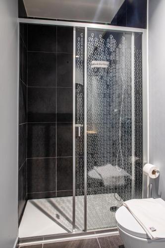 a shower with a glass door in a bathroom at Stay Hotel Lisboa Aeroporto in Lisbon