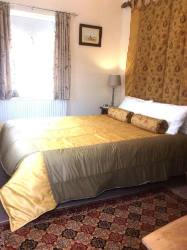 a bedroom with a large bed in a room at The Old Coach House in Bungay