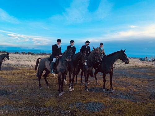 a group of people riding horses on a field at Stewards Bothy in Cornhill-on-tweed