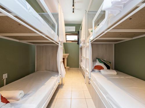 two bunk beds in a room with a hallway at Walk in Hostel Faro Airport in Faro