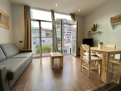 a living room with a couch and a table at Loft Pere IV in Barcelona