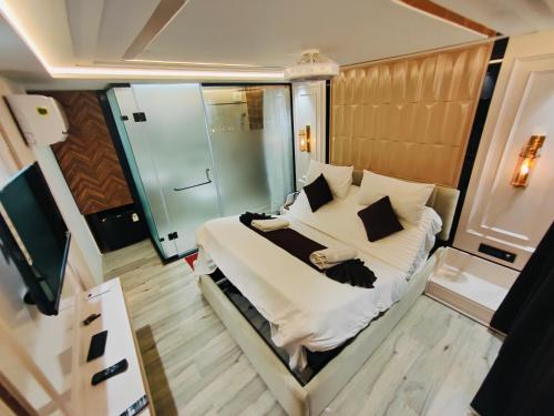 a bedroom with a bed with white sheets and pillows at The Vacation Villa in Agra