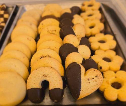 a tray of pastries with chocolate and cookies at Alle Porte in Riva del Garda