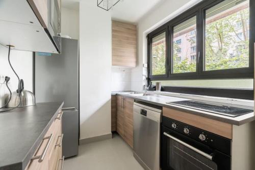 une cuisine avec un évier et une cuisinière dans l'établissement A Refined 2-bedroom close Avenue Foch, à Paris