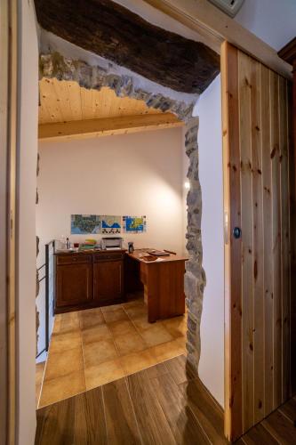 an entrance to a kitchen with a stone wall at Portico Rodriguez Abatemarco in Abatemarco