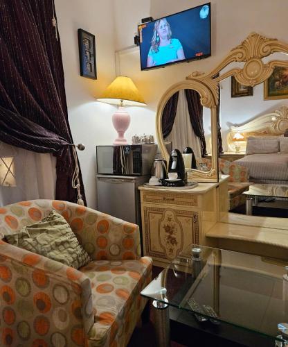 a living room with a couch and a mirror at The Royal Princess B&B on Malibongwe Drive in Johannesburg
