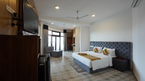 a bedroom with a large bed and a large window at Randiya Sea View Hotel in Mirissa