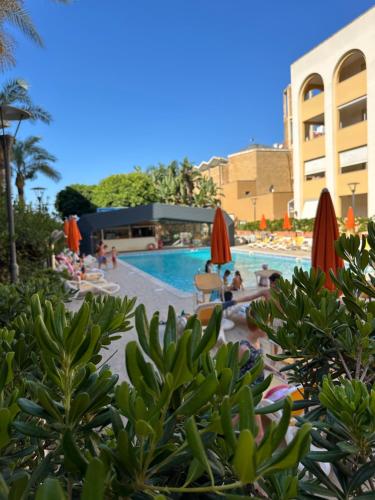 a pool at a resort with people lounging around at Waterfront Gallipoli 150 mt dal mare in Gallipoli