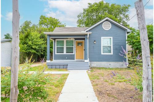 a blue house with a yellow door at Cozy and Gorgeous 2BR1BA Near Amazing Downtown in San Antonio