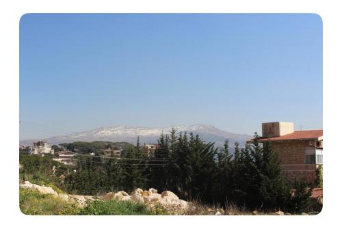 a view of a city with mountains in the background at Luxury Apartment Koneytra 2 Bedrooms - 2 Baths in Bekfaya