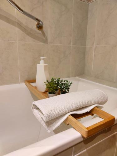 a bath tub with a towel on the edge of it at Tirwal Suite Judería in Teruel