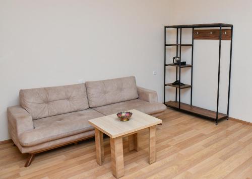 a living room with a couch and a table at Just Inn Kutaisi in Kutaisi