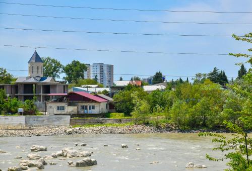 a river with a town in the background at Just Inn Kutaisi in Kutaisi