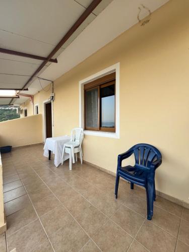 a room with two chairs and a table and a window at Dima's Apartments in Borsh