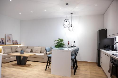 a kitchen and living room with a couch and a table at Kefaloviso Luxury Apartment 2 in Nafpaktos