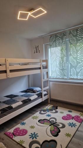 a bedroom with two bunk beds and a rug at Simona's place-Free private parking in Ljubljana