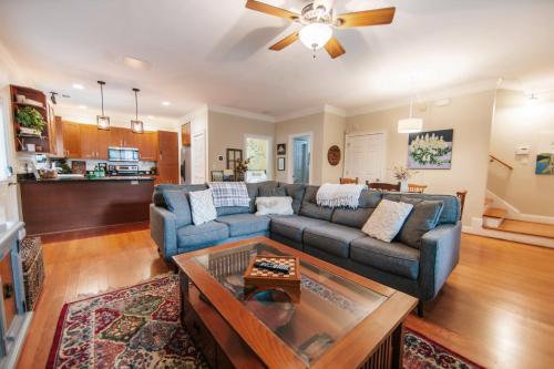 a living room with a couch and a table at Cozy Cottage - Walk to Campus, Stadium, Downtown in Athens
