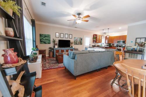 a living room with a couch and a table at Cozy Cottage - Walk to Campus, Stadium, Downtown in Athens