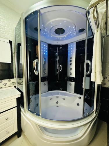 a bathroom with a tub in the middle of a room at Calm Corner Addis in Addis Ababa