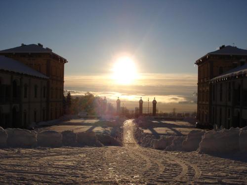 a sun setting over a street in a city at Santuario di Oropa in Biella
