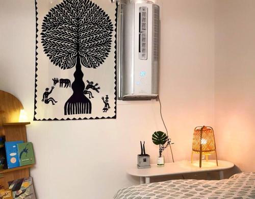 a bedroom with a tree picture on the wall at roasterblock 2BR flat 33m2 near Hongdea by the hanriver in Seoul