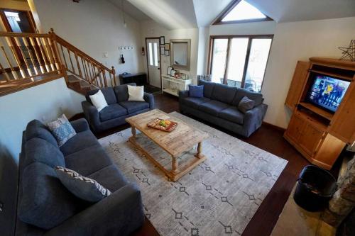 a living room with two couches and a coffee table at Big Blue Lake House complete with Game Room in Long Pond
