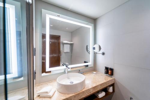 a bathroom with a sink and a mirror at Crowne Plaza Asunción by IHG in Asuncion