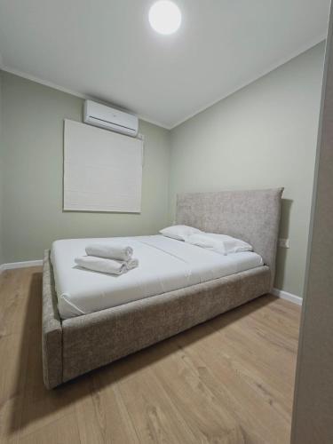 a bedroom with a large bed with a white mattressvisorvisor at GK apartments Ballerina in Bat Yam