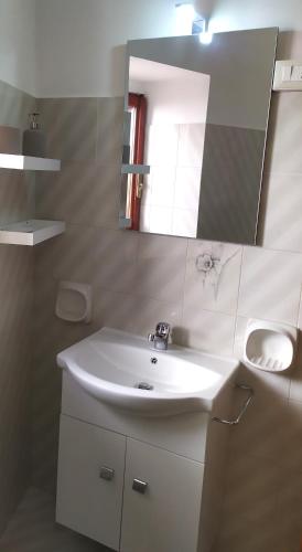 a bathroom with a white sink and a mirror at Vicolo 39 in Picerno
