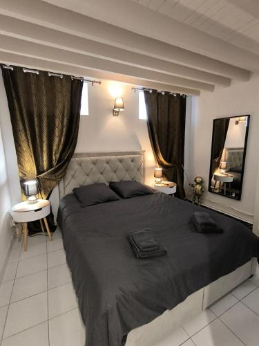 une chambre avec un grand lit et deux fenêtres dans l'établissement Aux Planches souplex hyper-centre, à Deauville