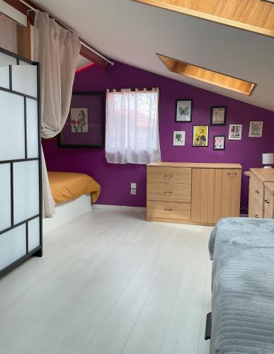 - une chambre avec des murs violets et un lit dans l'établissement Jolie maison cosy avec terrasse 600m plage, à Saint-Jean-de-Luz