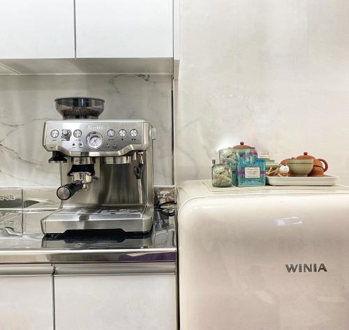 a kitchen with a coffee maker and a refrigerator at roasterblock 2BR flat 33m2 near Hongdea by the hanriver in Seoul