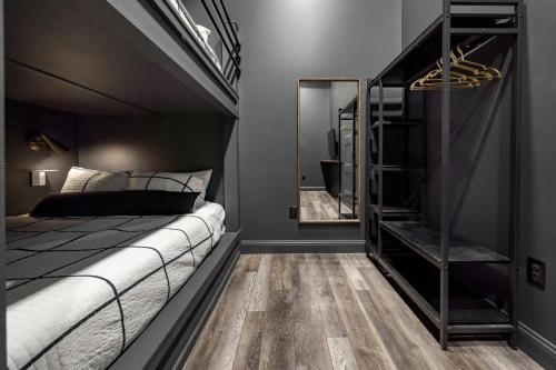 a bedroom with a bed and a mirror at Downtown Derby Delight in Louisville