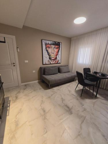 a living room with a couch and a table at GK apartments Ballerina in Bat Yam