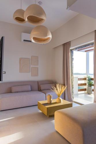 a living room with a couch and a table at Vouros Villages - Villa in Masouri