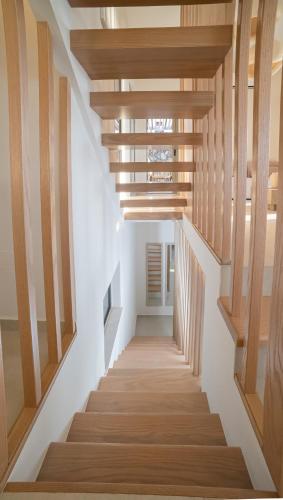 a hallway with wooden stairs in a house at Vouros Villages - Villa in Masouri