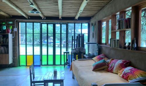 a living room with a couch and a table at Casa Qinti EcoHostel in Cosquín