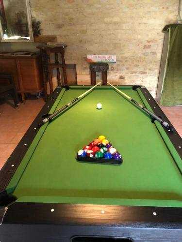a green pool table with cue balls on it at T-TWO Normandia in Nonant